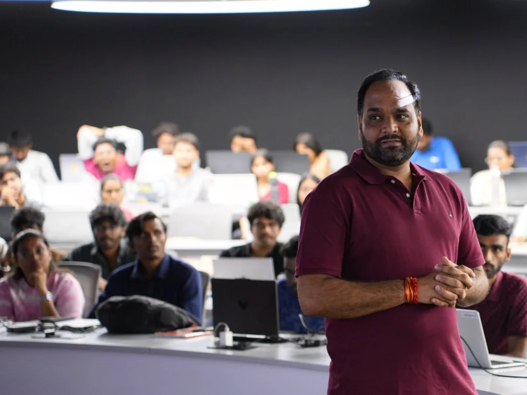 Databricks solution architect DD Sharma standing in a Polaris classroom of students at laptops