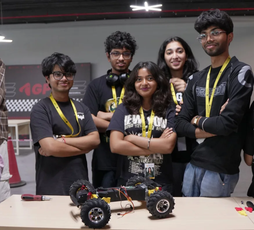 A Polaris GP Racing student team posing behind their rebuilt RC car